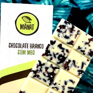 Quantas calorias em 1 porção (14 g) Chocolate Branco com Nibs de Cacau?