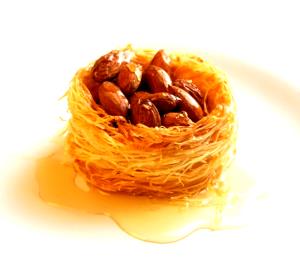 Quantas calorias em 1 Porçoes Ninho Árabe De Amendoas?
