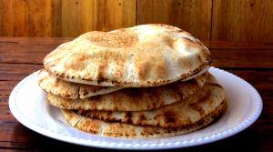 Quantas calorias em 1 Porçoes Pão Sírio Caseiro?